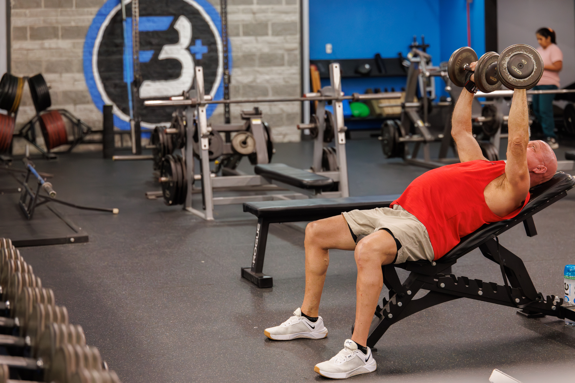 Incline bench area with FIT Beyond Plus branding visible in the background.