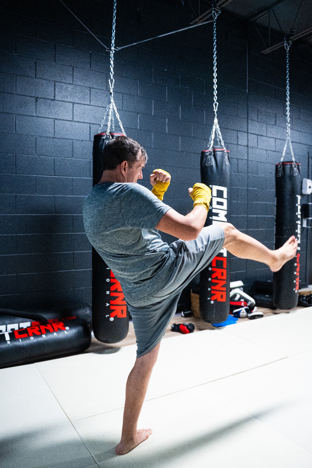 Kickboxing high kick on heavy bag at FIT Beyond Plus in Tullahoma