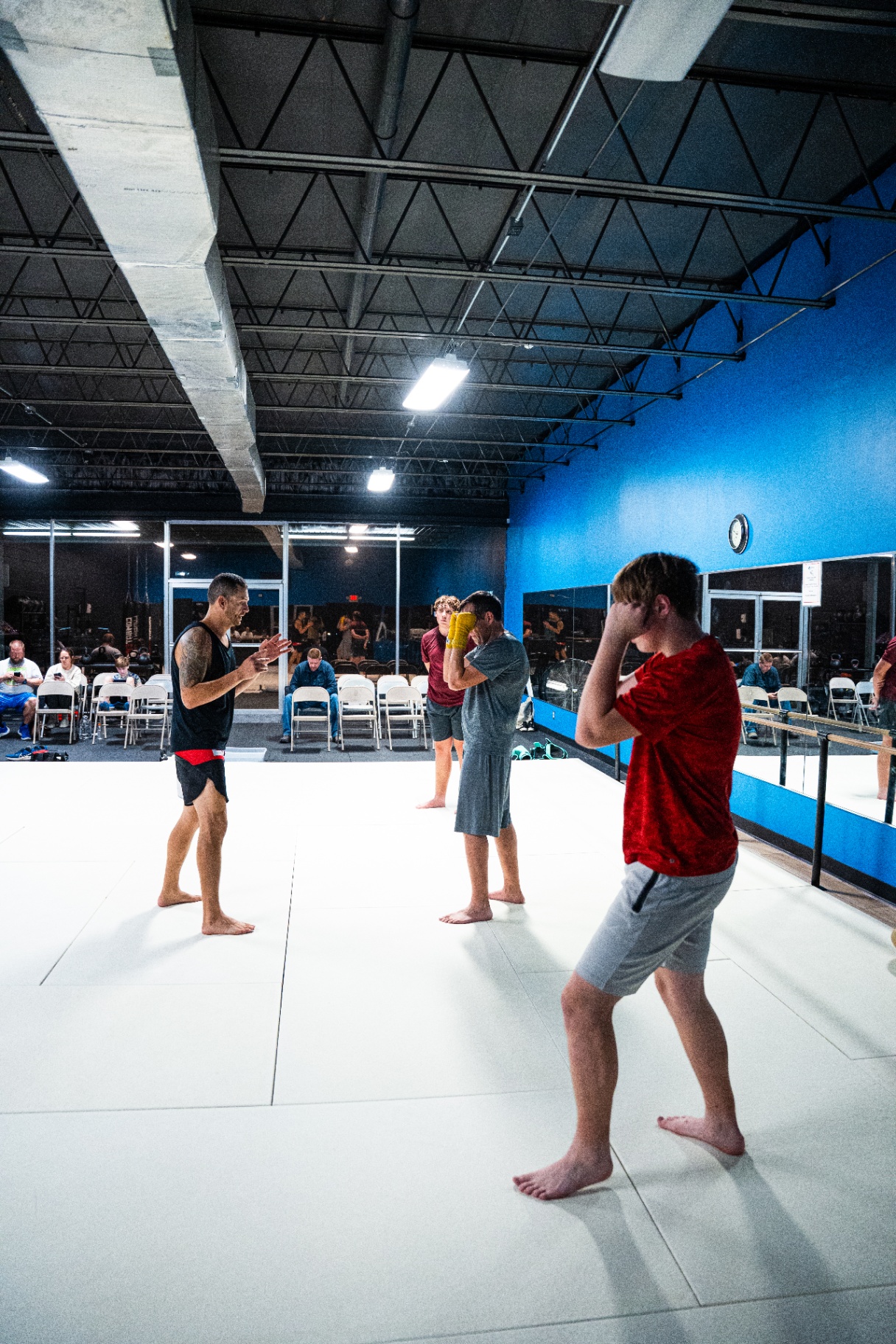 Coach leading kickboxing stance and guard drills at FIT Beyond Plus