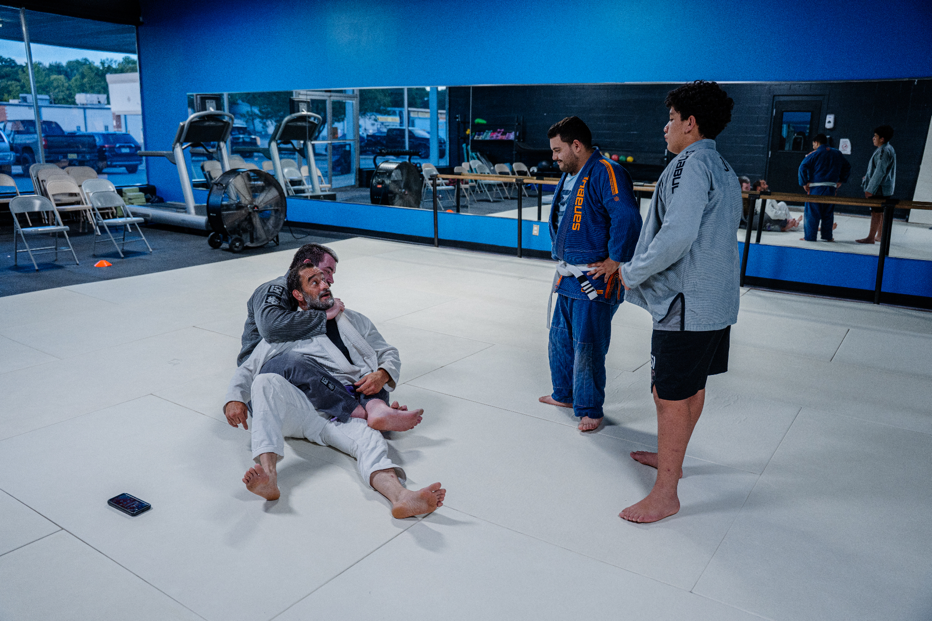 BJJ coach demonstrating a technique during class at FIT Beyond Plus